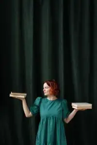 own your decisions, Amplify Your Message, Attract Clients, & Create Lasting Impact with Podcasts a woman weighing stacks of books - owning your decision
